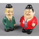 Two ceramic money boxes formed as Laurel and Hardy.