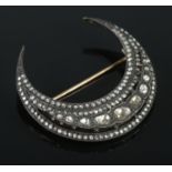 A vintage crescent formed brooch set with rough cut diamonds. Approximately 4.5cm x 4.5cm. Largest