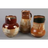 Three Doulton stoneware jugs. Includes silver mounted Lambeth example, Royal Doulton Dewars Whisky