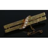 A 9ct gold double bar brooch set with seed pearls. 2.77g