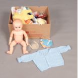 A box of doll's clothes and shoes including knitted example, also a vinyl doll.