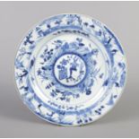 An 18th century Chinese dish decorated in underglaze blue with landscapes and figures. Diameter 25.