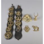 A quantity of brass including inkwell, stag figure and several buckles displayed on leather strap.