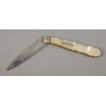 A large Victorian silver bladed and mother of pearl fruit knife with monogrammed crest and shell