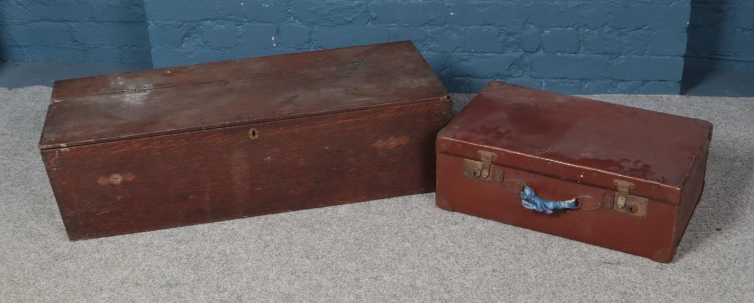 A long wooden lockable trunk along with leather suitcase. Trunk approx. 1m wide.