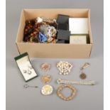 A box of assorted costume jewellery including necklaces, brooches, earrings and bracelets.