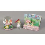 A quantity of Disney's Alice In Wonderland figures including storybook scene and snow globe etc.