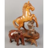 Three wooden figures. Including large rearing horse, elephant and a tiger.