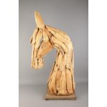 A large decorative wooden sculpture of a horse's head. Approx. 90cm tall including base.