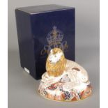 A boxed Royal Crown Derby paperweight formed as a Lion. With silver stopper.