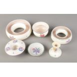 A quantity of Poole pottery including candlestick holder and small bowls.