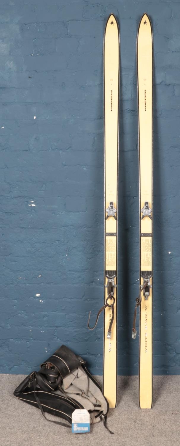 A pair of vintage Kneissl 'White Star' skis, in carry bag with label attached for the 'Earl of