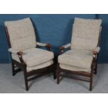 A pair of mahogany framed armchairs. With floral upholstery.