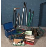 A collection of tools, garden tools and an outdoor lantern.