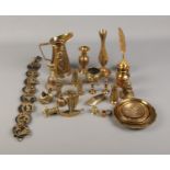 A box of assorted brassware including decorative jug, plates, novelty cauldron and inkwell.