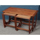 A nest of three teak G Plan Egomme tables. Ware to top of tables.