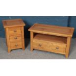 A modern bed side table set of drawers along with a matching cabinet.
