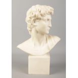 A small composite marble figure of Michelangelo's 'David'. Signed under left shoulder (