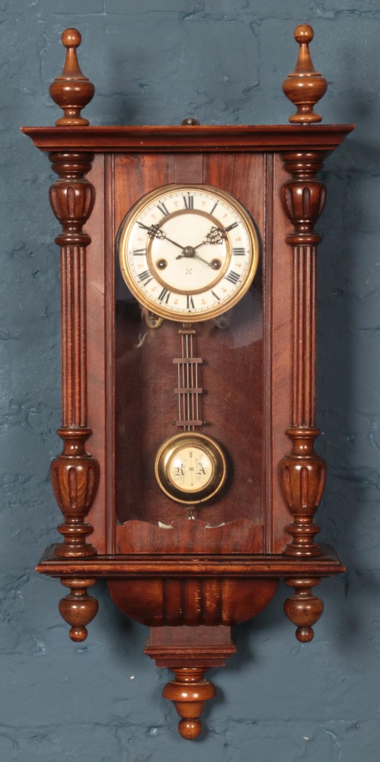 A Vienna wall clock, with crossed arrow dial for Hamburg American Clock Company. Turned finials to