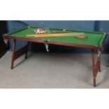 A slate pool table with accessories to include balls, cues etc.