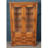 A Priory style carved light oak lead glazed display cabinet. (153cm x 91cm)