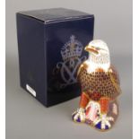 A Royal Crown Derby paperweight formed as an Eagle. With silver stopper.