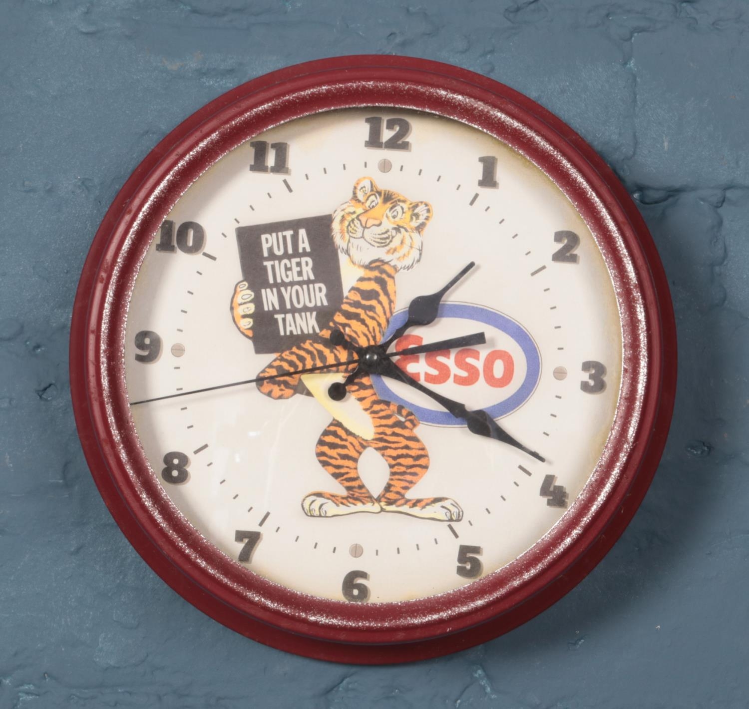 A quartz wall clock with dial advertising Esso. Diameter 30.5cm.