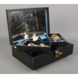 A musical jewellery box containing an assortement of costume jewellery; including white metal