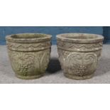 A pair of small concrete planters. Height 28cm, Diameter 32cm.