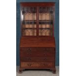 A mahogany and astragal glazed bureau bookcase, featuring fitted interior with shell motif.