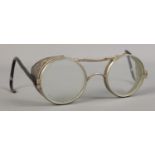 A pair of WWII era safety glasses. Stamped 'Made in England' to side of the lens.