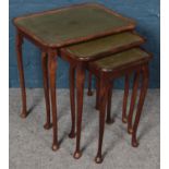 A nest of three leather top tables.