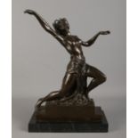 In the style of Bruno Zach; A bronze figure of a young maiden in dance. Raised on marble plinth.