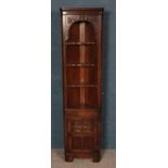 A Jaycee carved oak slender corner cabinet.