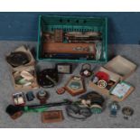 A large box of collectables. Including flash camera table lighter, fishing feels and hooks,