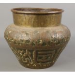 An Eastern brass planter decorated with animals. Height 20cm.