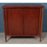 A mahogany side cabinet with sliding tambour front sliding doors. (86cm x 89cm x 45cm)