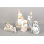 Five Nao by Lladro figures. Including large girl with pumpkins, girl with cat, girl with rabbit,