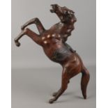 A leather clad model of a rearing horse. Height 44cm.