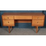 A five drawer sideboard raised on tapered legs. 150cm x 41cm x 72cm.