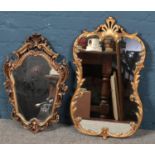 Two ornate gilt framed wall mirrors.