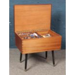A teak sewing box with contents.