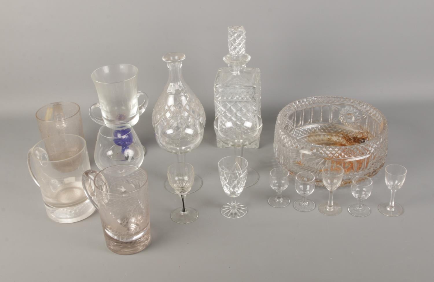 A quantity of glassware including decanters, commemorative tankards and cut glass bowl.