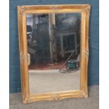 A gilt framed mirror. Dimensions including frame 35cm x 61cm.