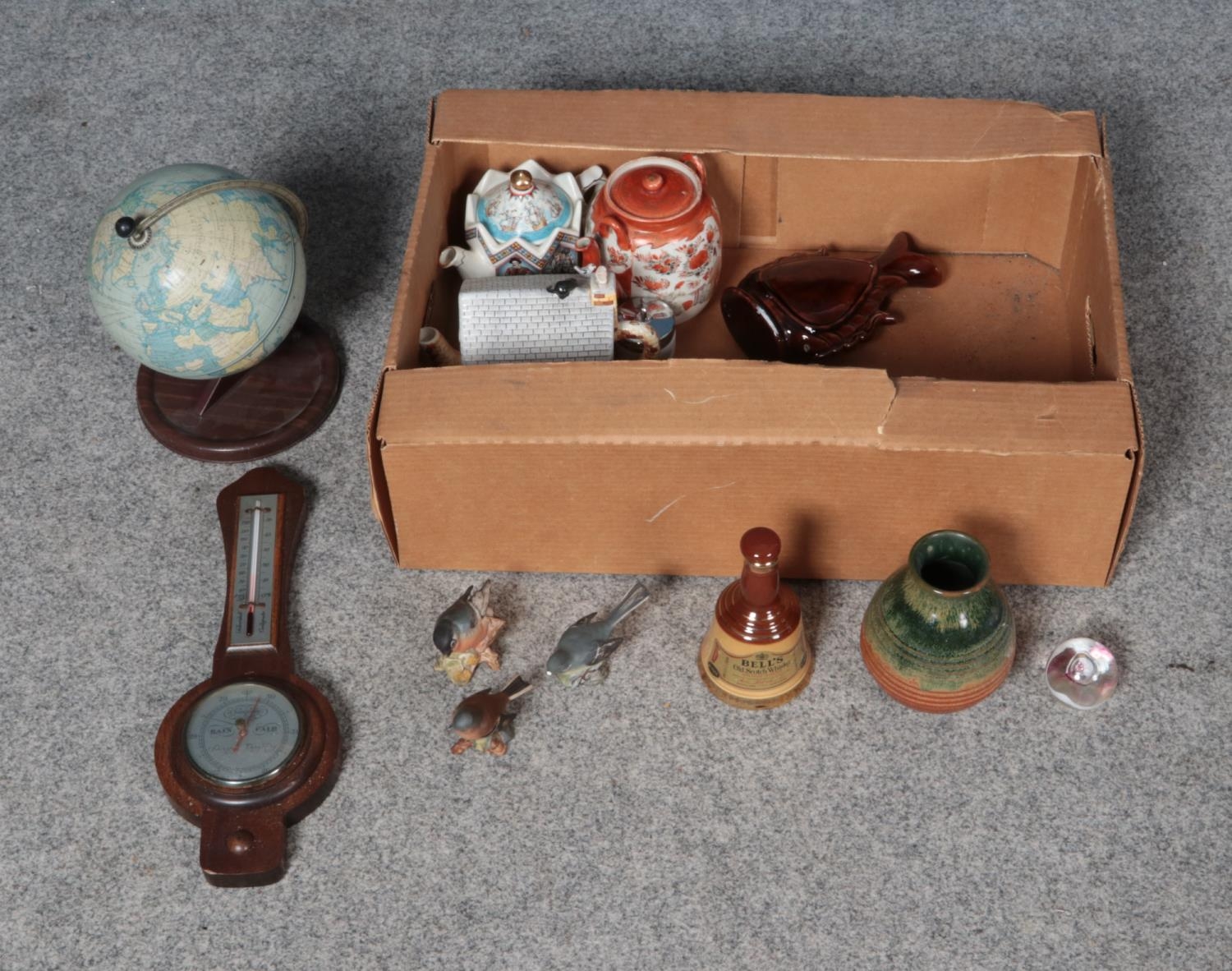 A box of miscellaneous to include banjo barometer, Beswick birds, tin globe and novelty Coronation