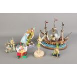 A quantity of Disney's Peter Pan figures including Ship snow globe, Peter and Wendy, Tinkerbell etc.