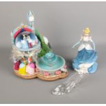 A quantity of Disney's Cinderella figures including snow globe fountain, glass slipper and