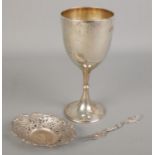 A silver goblet along with a white metal pierced dish and a Swedish silver fork.