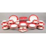A Crownford Burslem ceramic tea set, with red/white spot design, cups, saucers, side plates, milk