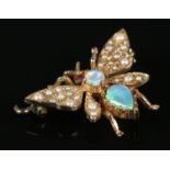 A 9ct Gold brooch, set with opals and seed pearls, in the form of a bee. Total weight: 3.74g In need